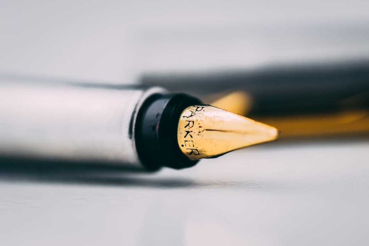 A fountain pen resting on a sheet of writing paper