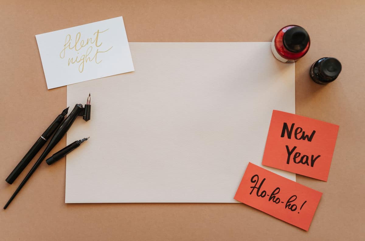 Calligraphic writing on paper beside a fountain pen