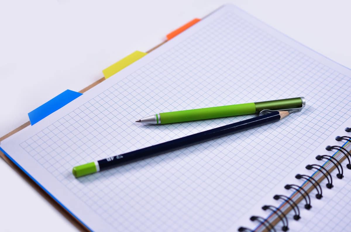 A notebook page of graph paper with a fountain pen