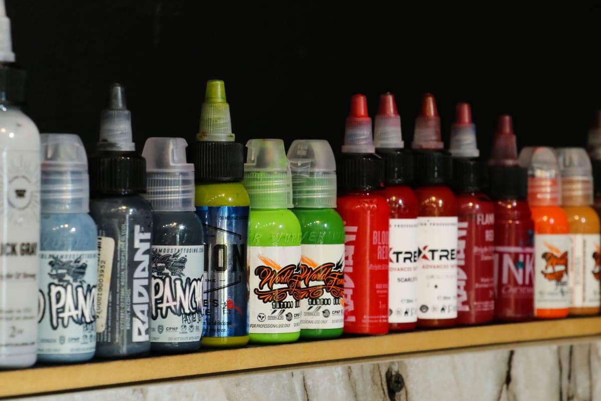 A collection of ink bottles arranged on a shelf
