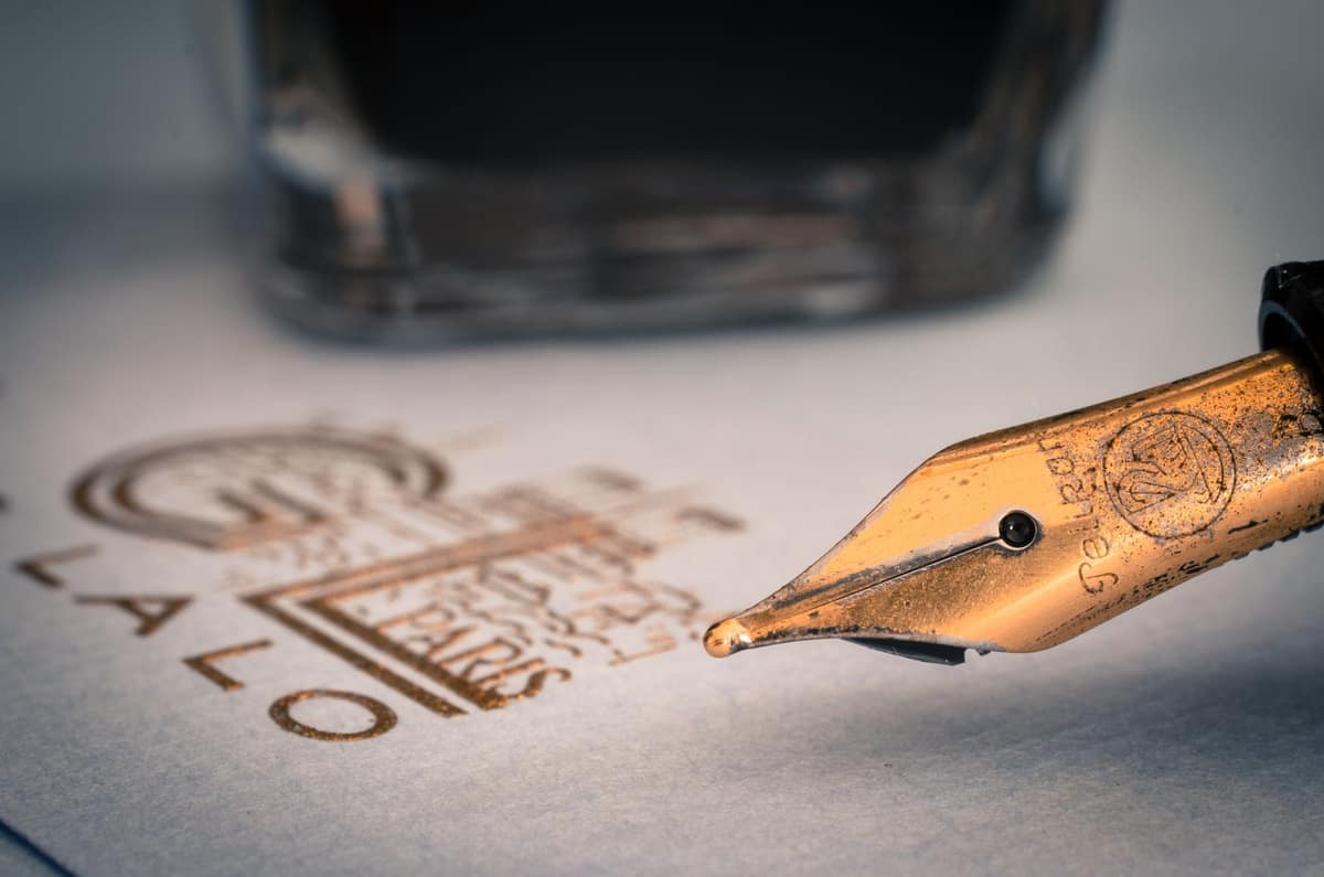 A clear-bodied fountain pen with the ink visible inside