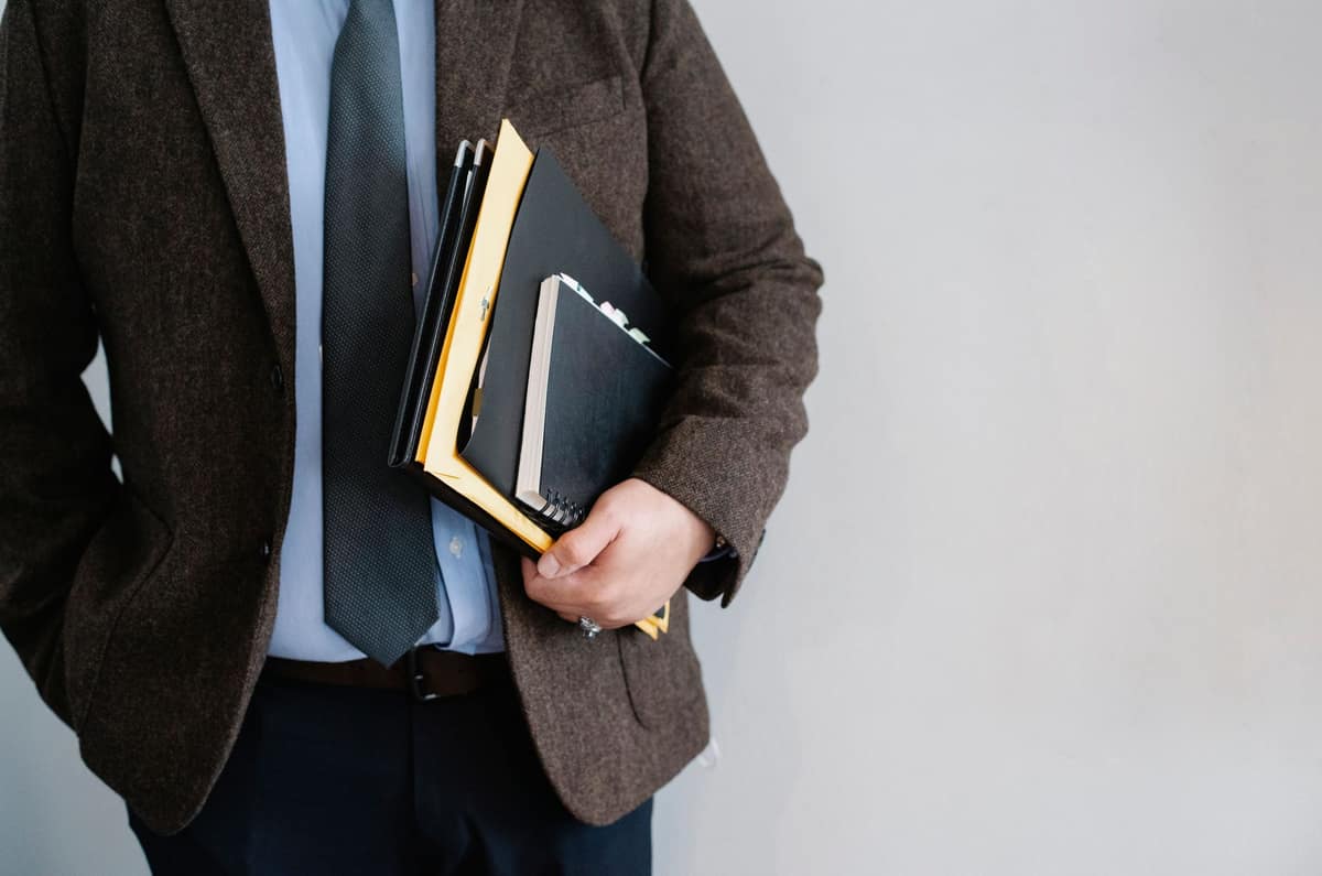 A small notebook and pen in a jacket pocket
