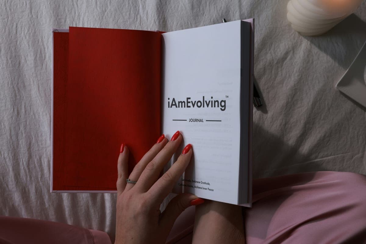A guided journal open on a bed