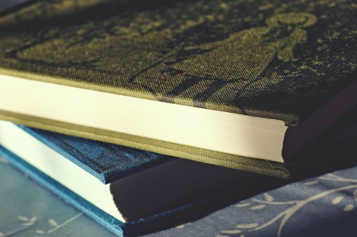 Two hardcover notebooks stacked on a desk
