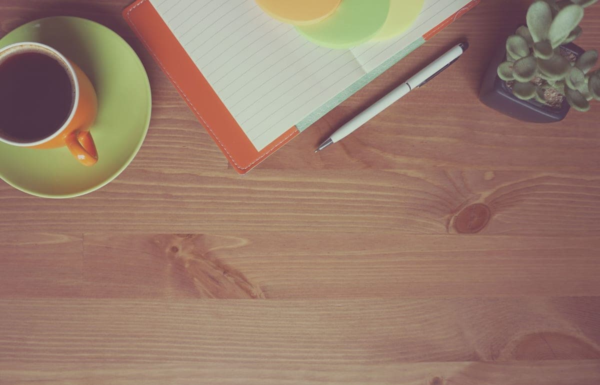 An orange notepad on a desk