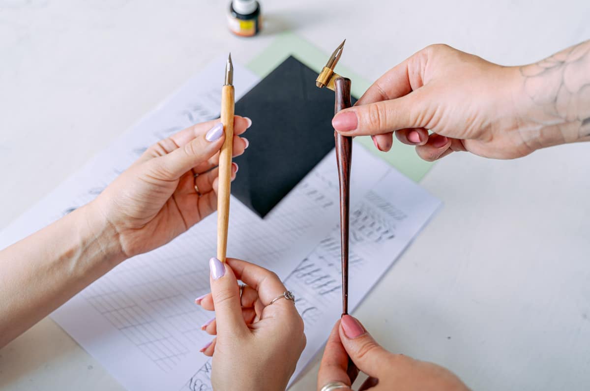 Two similar fountain pens side by side on a plain background