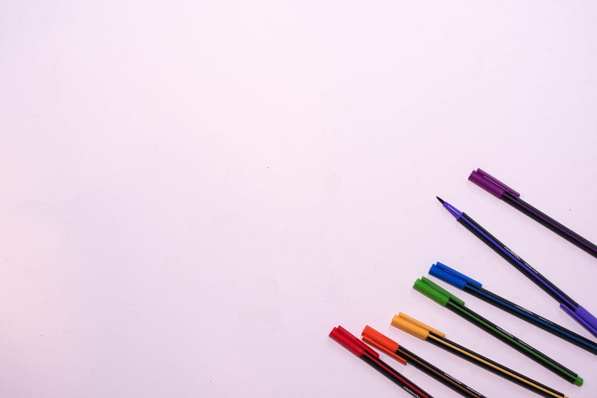 Colorful fountain pens arranged on a white desk