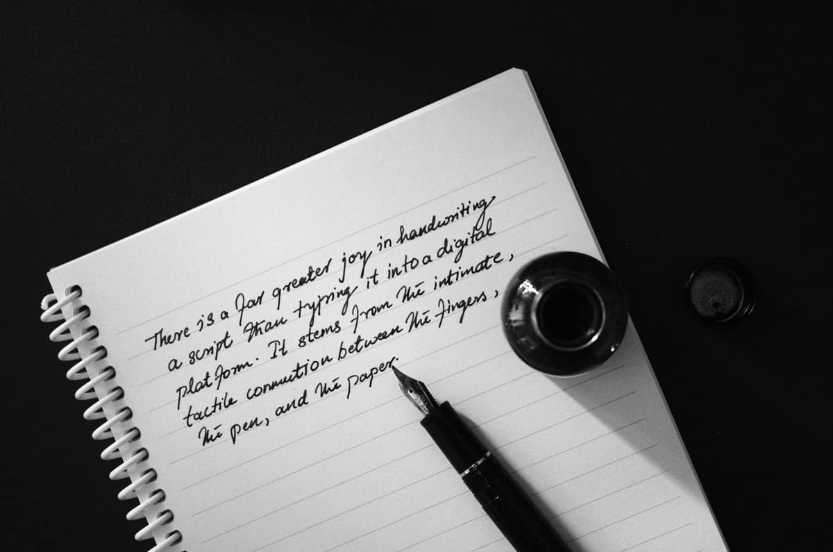A clear demonstrator fountain pen showing the ink inside its barrel