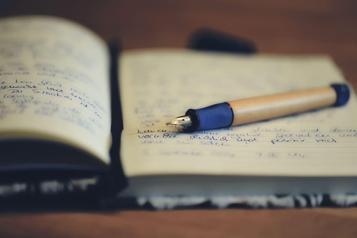 A fountain pen photographed close up on a dark surface